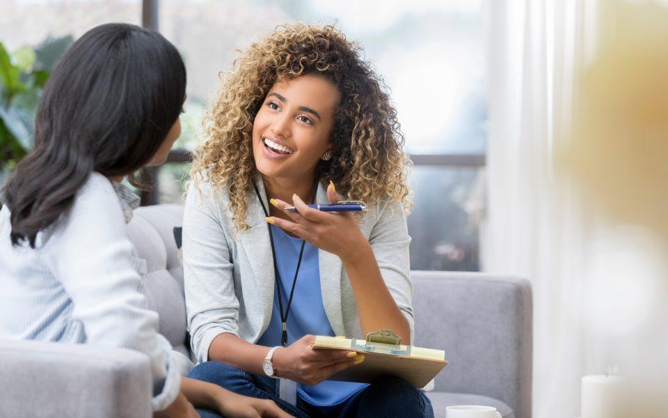 Encouraging therapist talks with young woman